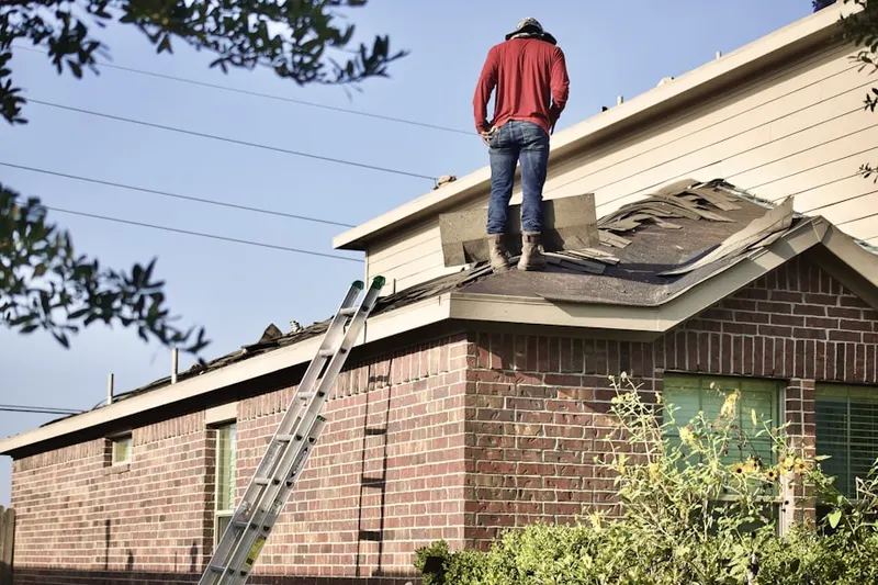Professional roofer working on a residential roof in Woodstock